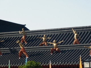 golden monks on roof